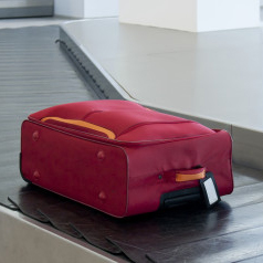 Suitcase on airport conveyor belt